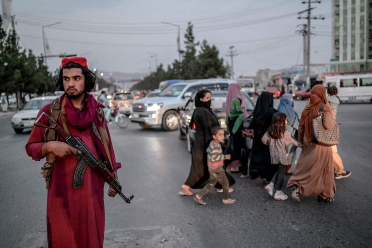 A member of Taliban stands guard along a road in Kabul on 30 September 2021